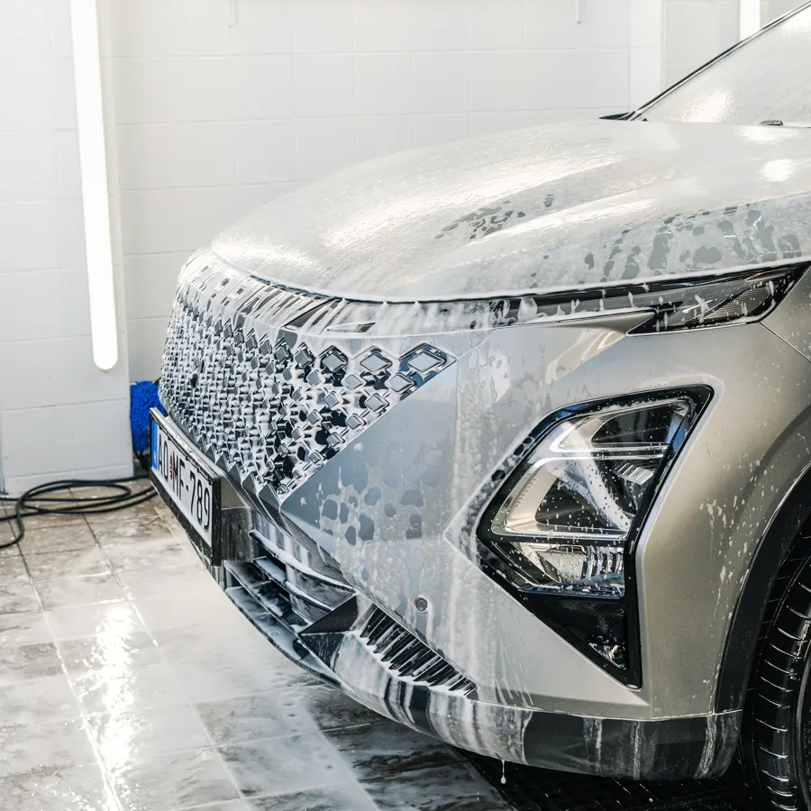 Car front covered in active foam during the pre-wash